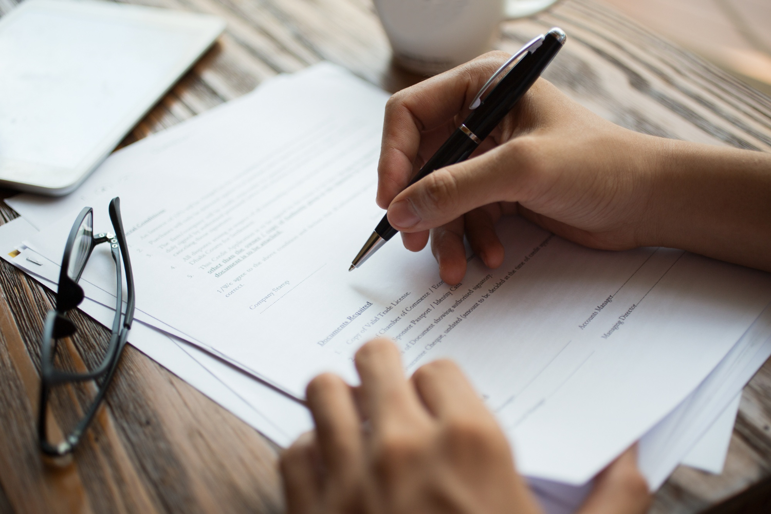 businessman-examining-papers-table