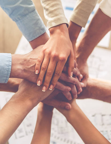 Top view of business people holding hands together, cropped
